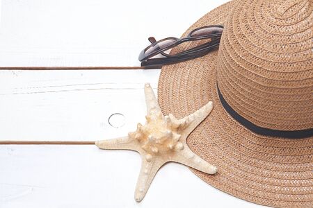 Starfish, straw hat and sunglasses on a sunny day. The concept of relaxation.の写真素材