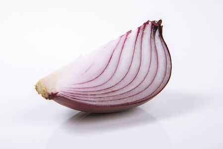 Red onion on the white wooden background.の写真素材