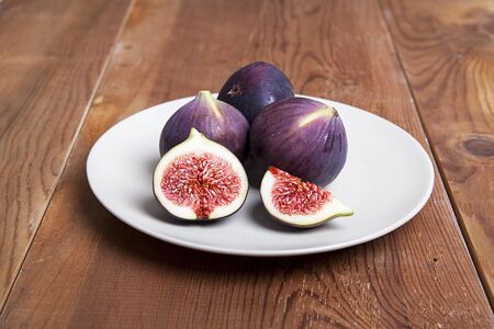Fresh fruits, figs on the wooden background.