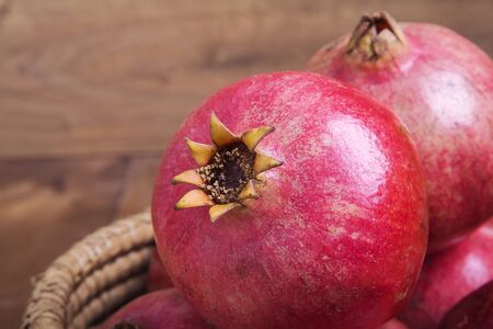 Red juicy pomegranate on rustic wooden table.の写真素材