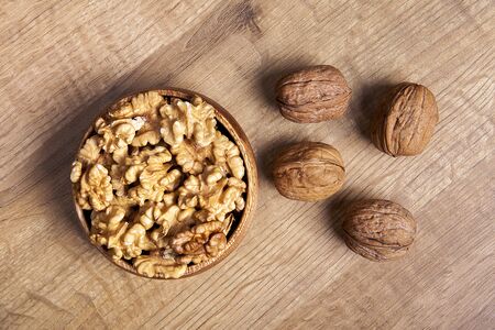 Walnut in a bowls on wooden table. Healthy food and snack.の写真素材