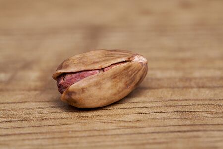 Pistachio on wooden table. Healthy food and snack.
