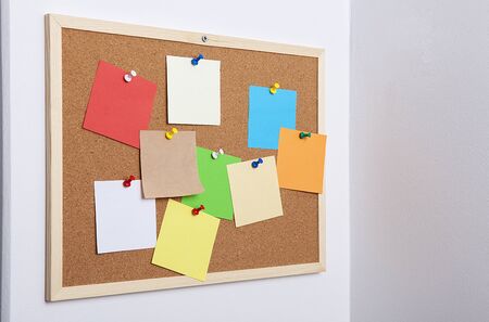 Colorful note papers on cork board (bulletin board).の写真素材