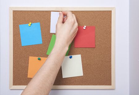 Colorful note papers on cork board (bulletin board).の写真素材