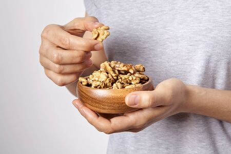 Woman's in hand roasted and dry chickpeas in a bowls.