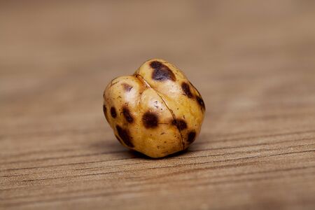 Roasted and dry chickpeas on wooden table.の写真素材