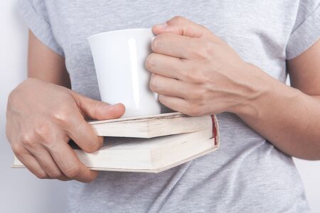 Young woman is drinking coffee over white background.