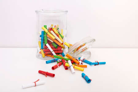 Small roll wish papers and a jar on white background. Wish jar. Wish concept. Dream, desire, wish,...