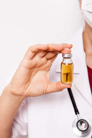 The doctor is holding medicine bottle in her hand.