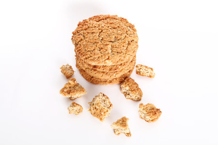 Oatmeal, fig, hazelnut, pistachio and sesame cookies on a white background. Enjoyable snack.の写真素材