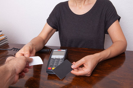Contactless payment by credit card. POS terminal NFC payment. Concept of how to choose payment method for shopping in a store.の写真素材