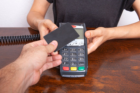 Contactless payment by credit card. POS terminal NFC payment. Concept of how to choose payment method for shopping in a store.の写真素材
