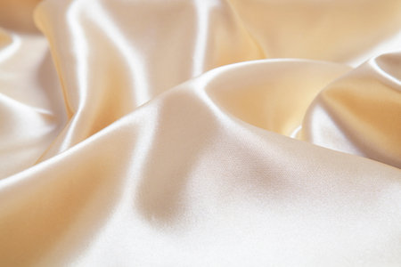 Elegant yellow silk satin fabric background.の写真素材