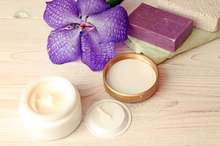 Still life with cream jar, flower, soap and pumiceの写真素材