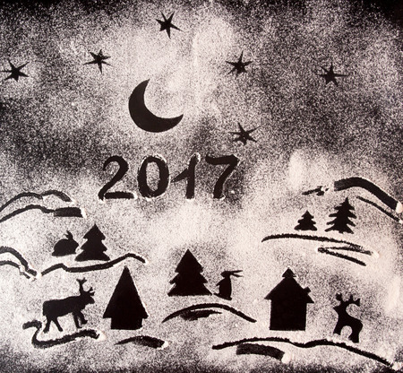 New Year holiday background. Drawing with flour, prints of various figures: fir trees, deer, elk,...