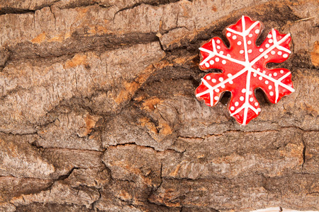Christmas New Year holiday background. Red gingerbread cookie on bark. Top view. Copy spaceの写真素材