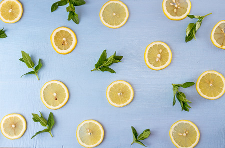 Flat lay still life with mint and lemon on blue background. Pop art trend still lifeの写真素材