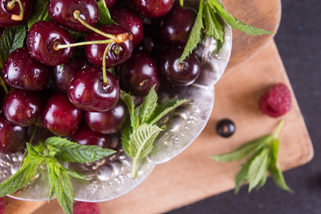 Fresh sweet cherries with drops of water on tray. Selective focus. Top view.の写真素材