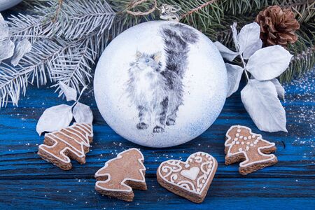 Christmas New Year decorations. Christmas ball, branch of Christmas tree and gingerbread cookies.の写真素材
