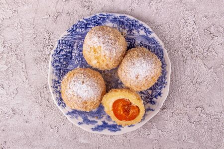 Austrian and czech sweet dessert knedle apricot dumplings on gray concrete background. Filled...