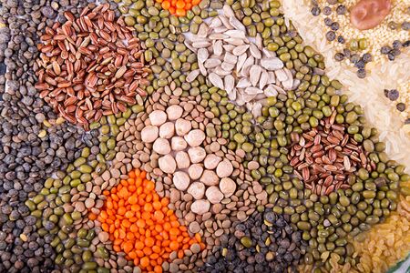 Food background. Stylized food map of various Legumes, sereals, beans, grain and seeds. Kind of lentils, bulgur, mash, chickpeas, sunflower seeds, couscous, rice.の写真素材