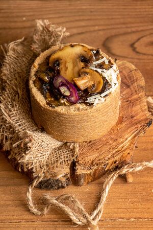 Tarts with mushrooms, caramelized red onion and cheese over on old wooden rustic background.の写真素材