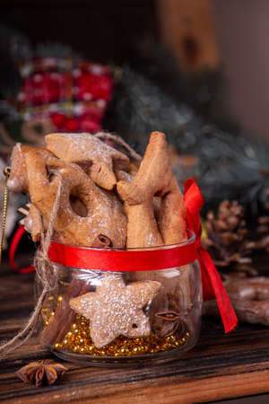 Gingerbread cookies on glass jar, Christmas and New Year ornament on old wooden background. Overhead of Christmas New Year holiday background. Copy spaceの写真素材