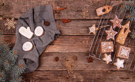 Greeting card with decor gingerbread cookies, Christmas and New Year ornament on old wooden background. Overhead of Christmas New Year holiday background. Top view. Copy spaceの写真素材