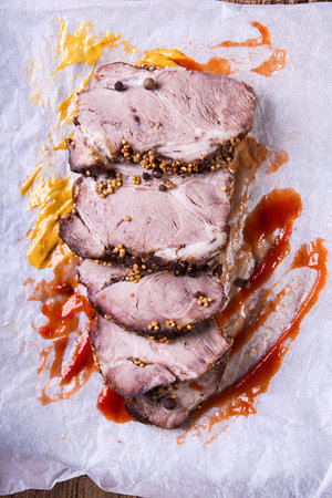 Slices of roasted meat. Cold-boiled pork on parchmentの写真素材