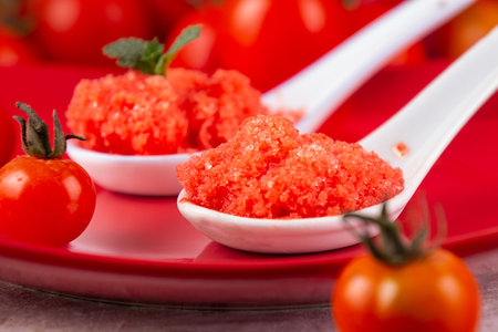 Spoons of fresh tomato sorbet. Red and white color picturesの写真素材