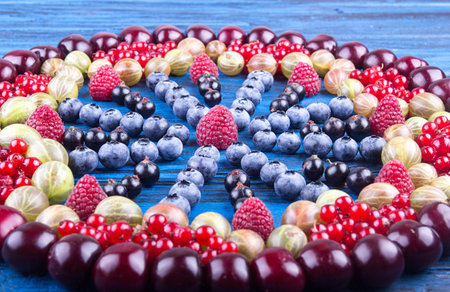 Ornament of assorted fruits and berries: gooseberries, raspberry, red and black currant, blueberry,...