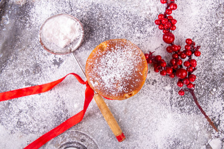 Italian sweet dessert panettone over on sugar powder surfase. rich Italian bread made with eggs, fruit, and butter and typically eaten at Christmasの写真素材