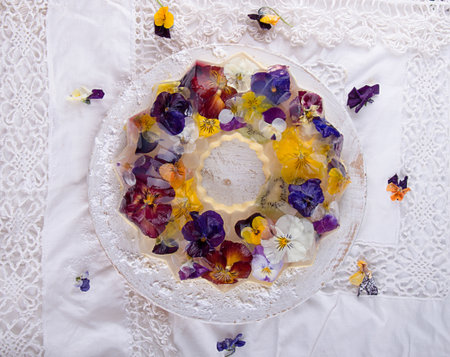 Unique japanese dessert of jelly and bavarian cream with edible violet flowers. Gelatin healthy...
