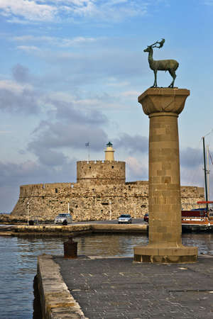Lighthouse and deer statue in Mandraki harbor, where the Colossus of Rhodes once stood, Greeceの写真素材