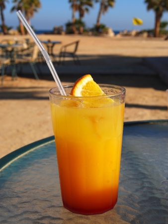 Beach yellow cocktail on a glass tableの写真素材