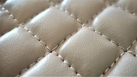 texture of beige artificial leather with constricting closeup