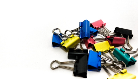 Multicolored paper clips in a pile closeup on a white backgroundの写真素材
