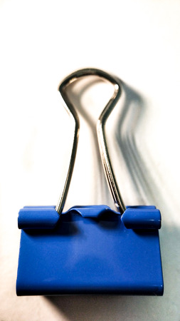 One blue cyan paper clip closeup on white backgroundの写真素材