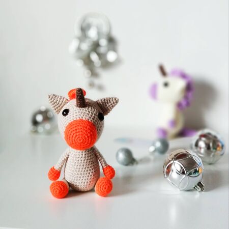 Knitted unicorn toy Christmas gift on a light background. Crafts, hand-madeの写真素材