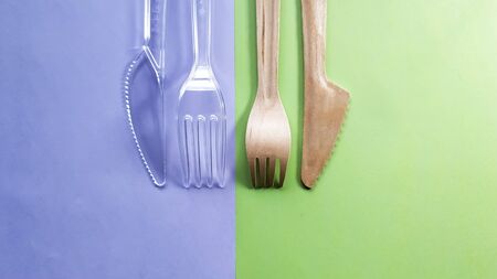Comparison of plastic and bamboo wooden fork and knife. Eco-friendly disposable cutlery. Caring for the environmentの写真素材