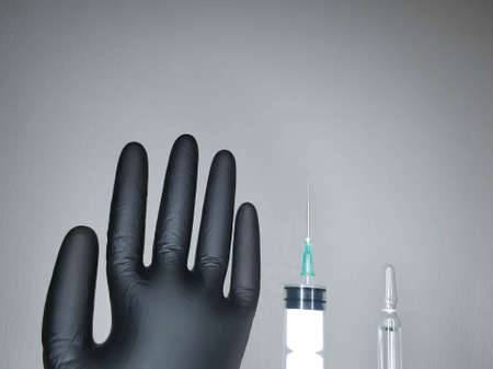Syringe and ampoule on a light background close-up.