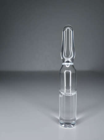 One glass ampoule on light white background close upの写真素材