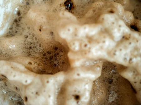 Foam on coffee and cola drink. Brown foam interspersed close-upの写真素材