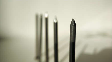 Nails hardware in a row close-up on light background.の写真素材