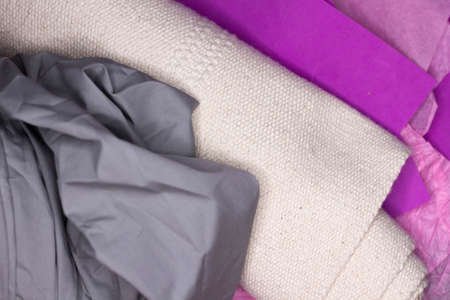 Different fabrics and materials in gray, pink and white colors close-upの写真素材