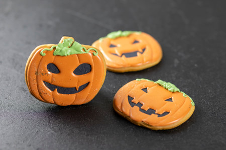 Bright happy Halloween gingerbread cookies on a black backgroundの写真素材