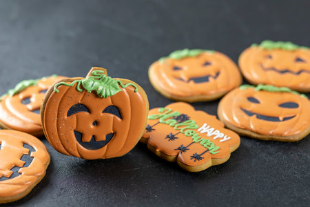 Bright Halloween gingerbread cookies on a black backgroundの写真素材