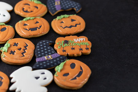 Bright Halloween gingerbread cookies on a black backgroundの写真素材