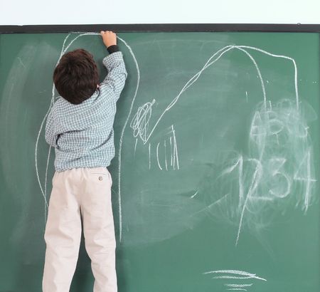 Preschooler drawing on chalkboard. Series...の写真素材