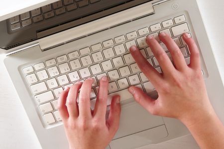 Typing on laptop.